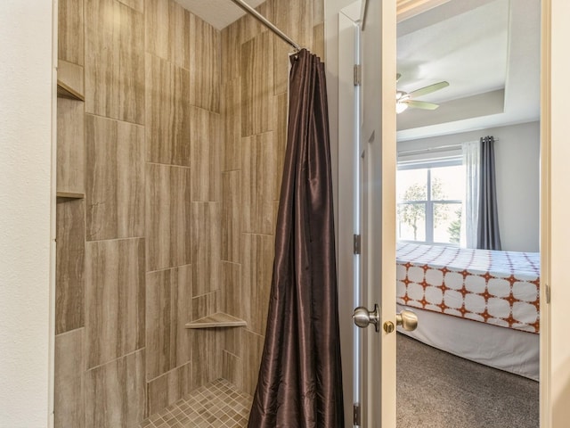 8955 Jamison Dr, West Des Moines, IA 50266 - full bathroom featuring a tile shower, a ceiling fan, connected bathroom, and a tray ceiling