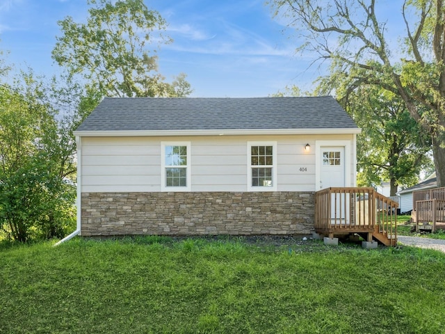 404 S B St, Indianola, IA 50125 - view of front of home featuring stone siding, a front lawn, and a shingled roof
