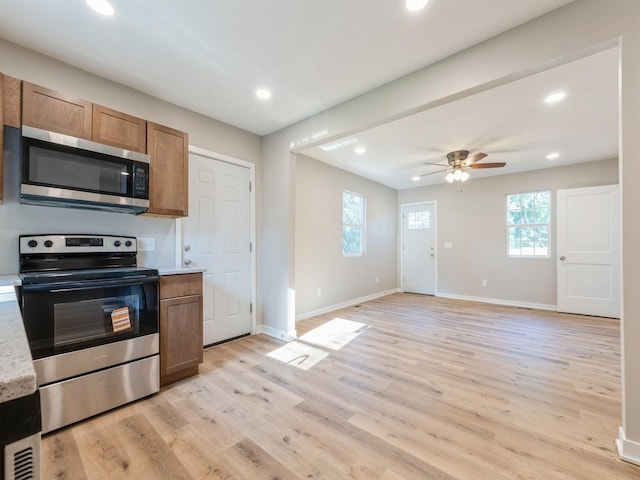 404 S B St, Indianola, IA 50125 - kitchen featuring stainless steel appliances, light countertops, a ceiling fan, light wood-style flooring, and recessed lighting