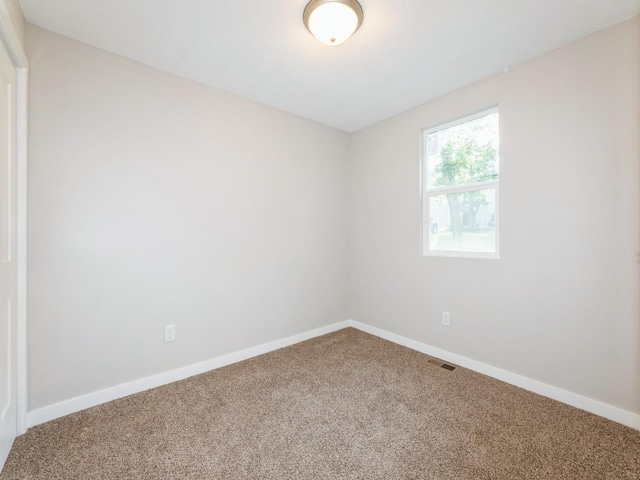 404 S B St, Indianola, IA 50125 - unfurnished room featuring carpet flooring and baseboards