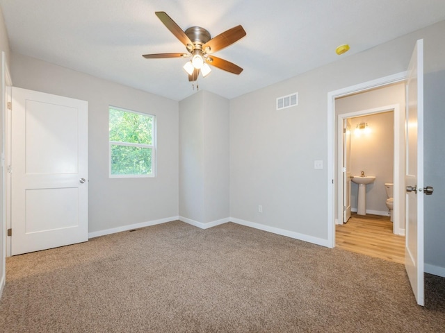 404 S B St, Indianola, IA 50125 - unfurnished bedroom featuring carpet flooring and ceiling fan