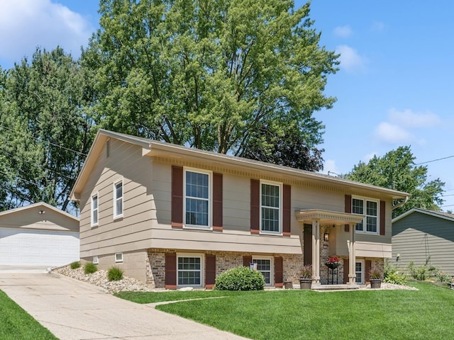 4408 66th St, Urbandale, IA 50322 - raised ranch featuring an outbuilding, a front yard, and a garage