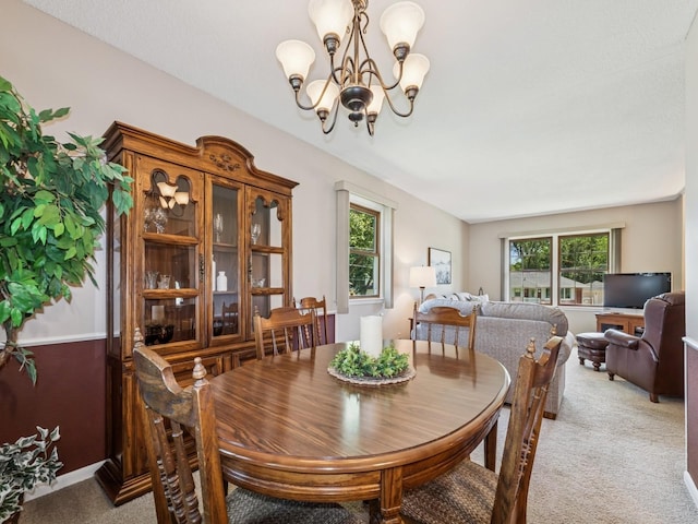 4408 66th St, Urbandale, IA 50322 - dining area with light carpet, healthy amount of natural light, and a chandelier