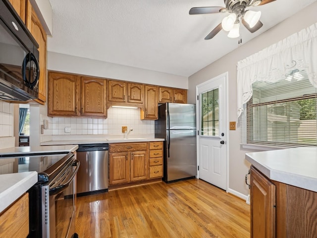 4408 66th St, Urbandale, IA 50322 - kitchen featuring stainless steel appliances and brown cabinetry
