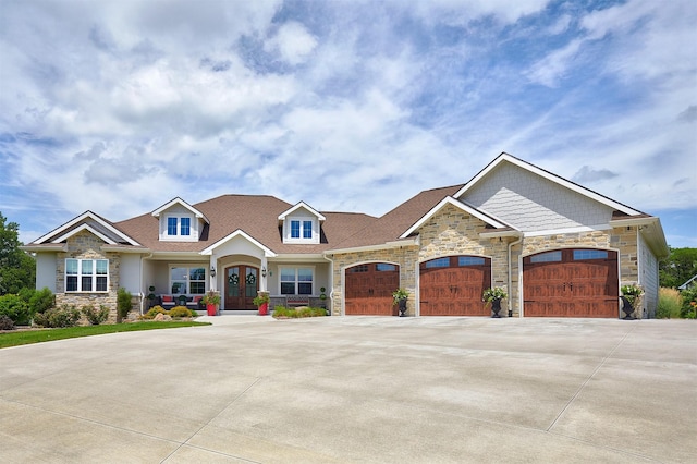 11174 NW 108th Ct, Granger, IA 50109 - view of front facade with stone siding, a garage, concrete driveway, and french doors