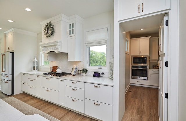 11174 NW 108th Ct, Granger, IA 50109 - kitchen with appliances with stainless steel finishes, recessed lighting, tasteful backsplash, white cabinetry, and light countertops