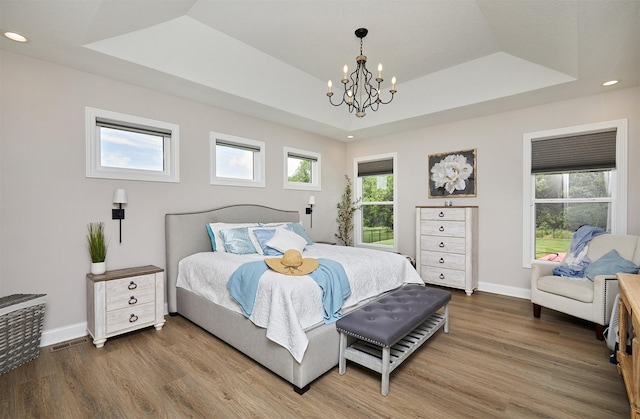 11174 NW 108th Ct, Granger, IA 50109 - bedroom featuring wood finished floors, a chandelier, recessed lighting, and a raised ceiling