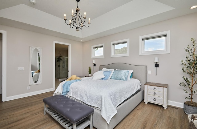 11174 NW 108th Ct, Granger, IA 50109 - bedroom with a chandelier, wood finished floors, and connected bathroom