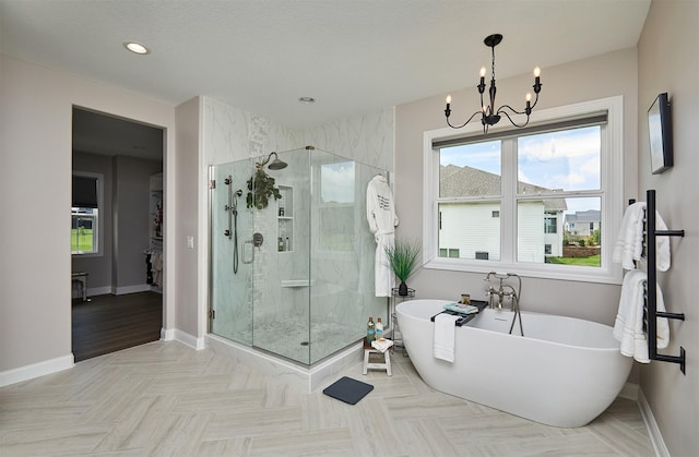 11174 NW 108th Ct, Granger, IA 50109 - bathroom featuring plenty of natural light, a shower stall, a soaking tub, and recessed lighting