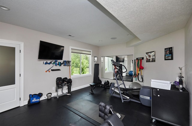 11174 NW 108th Ct, Granger, IA 50109 - exercise area featuring a textured ceiling and baseboards