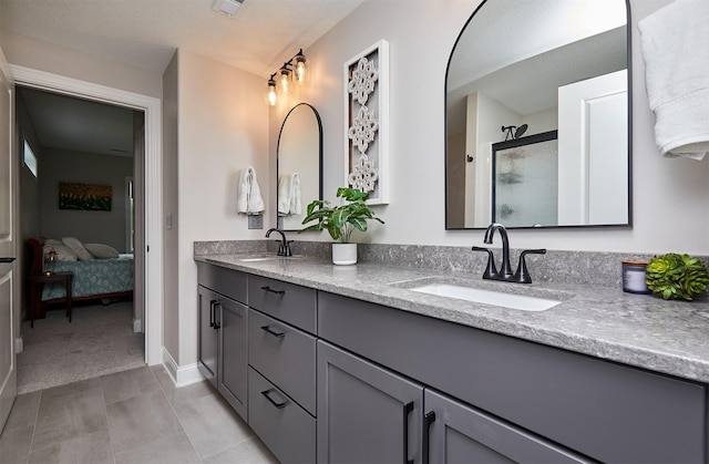 11174 NW 108th Ct, Granger, IA 50109 - ensuite bathroom with double vanity, a stall shower, and tile patterned floors