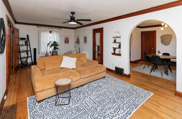 2220 York St, Des Moines, IA 50316 - living area featuring arched walkways, a ceiling fan, wood finished floors, and ornamental molding