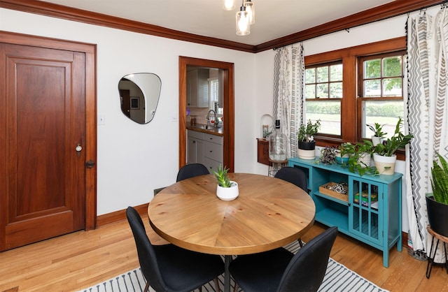 2220 York St, Des Moines, IA 50316 - dining room featuring light wood-type flooring and crown molding
