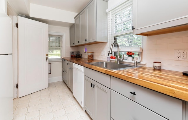 2220 York St, Des Moines, IA 50316 - kitchen with white appliances, wood counters, decorative backsplash, light flooring, and gray cabinets