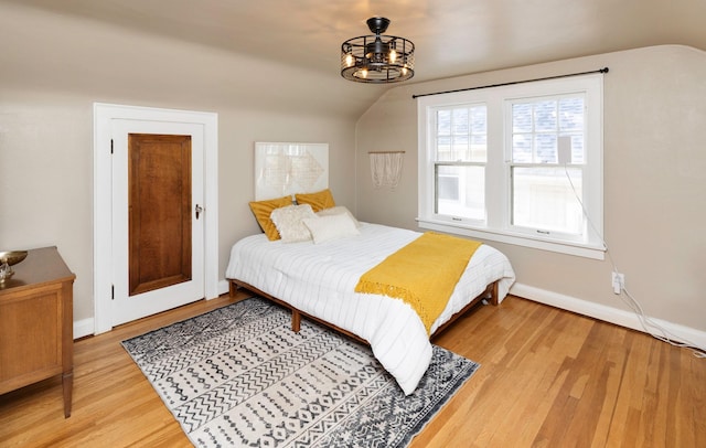 2220 York St, Des Moines, IA 50316 - bedroom with light wood finished floors, lofted ceiling, and a chandelier