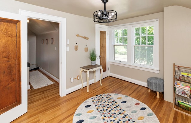 2220 York St, Des Moines, IA 50316 - rec room featuring light wood finished floors and a chandelier