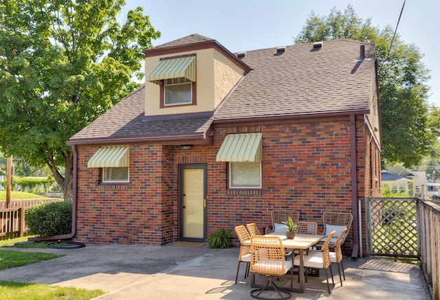 2220 York St, Des Moines, IA 50316 - back of property with a patio, brick siding, and a shingled roof
