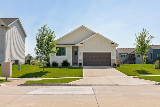 2845 SE Bluestem Dr, Waukee, IA 50263 - ranch-style home with an attached garage, driveway, a front yard, and board and batten siding