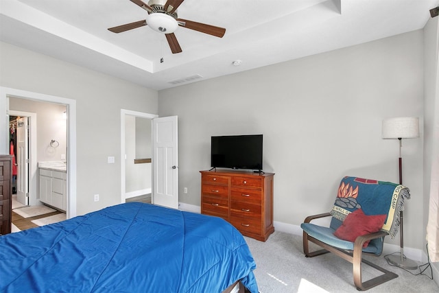2845 SE Bluestem Dr, Waukee, IA 50263 - bedroom with a raised ceiling, ceiling fan, connected bathroom, and carpet