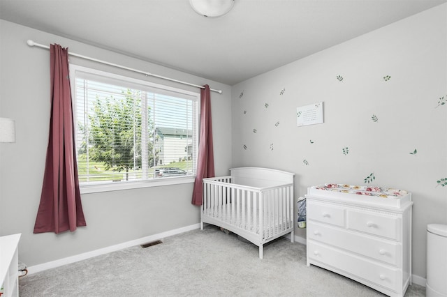 2845 SE Bluestem Dr, Waukee, IA 50263 - bedroom featuring light colored carpet and a crib