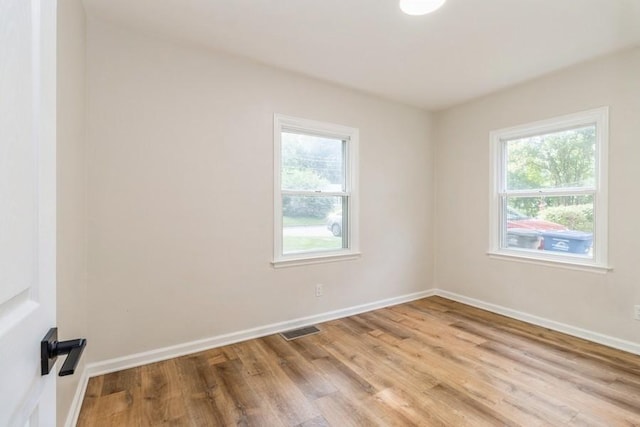 3901 Lawnwoods Dr, Des Moines, IA 50310 - empty room featuring plenty of natural light and wood finished floors