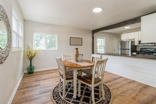 3901 Lawnwoods Dr, Des Moines, IA 50310 - dining area featuring light wood finished floors, healthy amount of natural light, recessed lighting, and beam ceiling