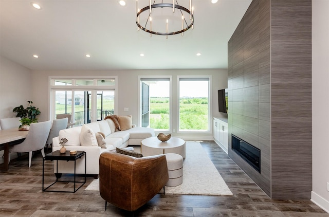 16320 Northpark Dr, Urbandale, IA 50323 - living area with dark wood finished floors, recessed lighting, a fireplace, and a chandelier