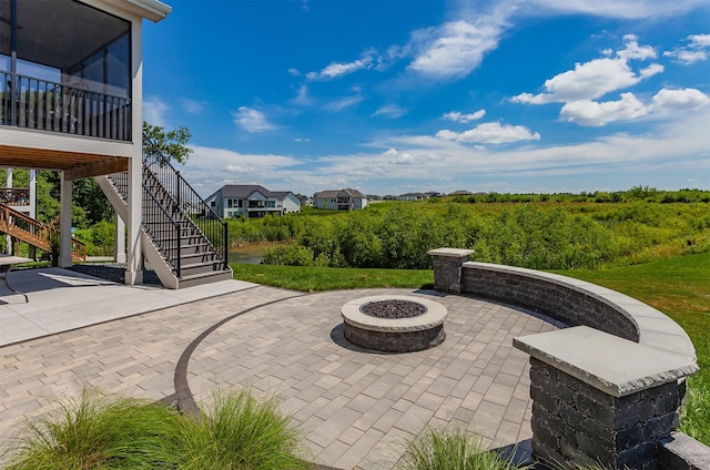 16320 Northpark Dr, Urbandale, IA 50323 - view of patio featuring stairway and a fire pit