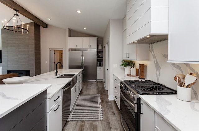 16320 Northpark Dr, Urbandale, IA 50323 - kitchen featuring stainless steel appliances, a chandelier, dark wood-style floors, white cabinetry, and light stone counters