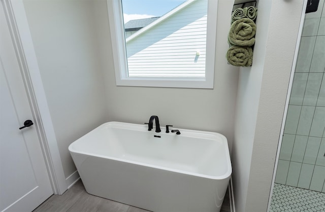 16320 Northpark Dr, Urbandale, IA 50323 - bathroom with healthy amount of natural light and a soaking tub