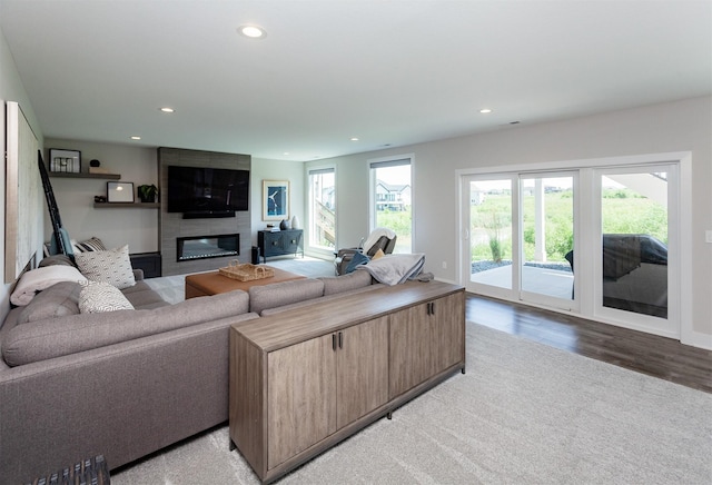 16320 Northpark Dr, Urbandale, IA 50323 - living room featuring recessed lighting, plenty of natural light, a large fireplace, and light wood-style floors