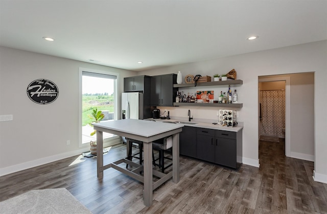 16320 Northpark Dr, Urbandale, IA 50323 - kitchen with open shelves, light countertops, dark wood-style flooring, recessed lighting, and refrigerator with ice dispenser