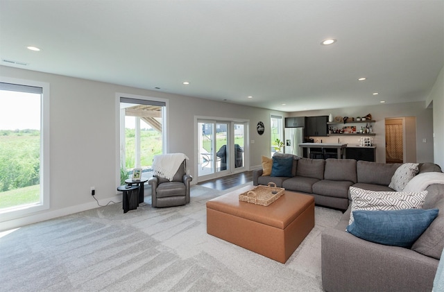 16320 Northpark Dr, Urbandale, IA 50323 - living area featuring recessed lighting, bar area, and light carpet