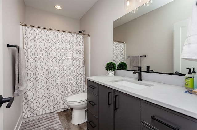 16320 Northpark Dr, Urbandale, IA 50323 - full bathroom with vanity, wood finished floors, and recessed lighting