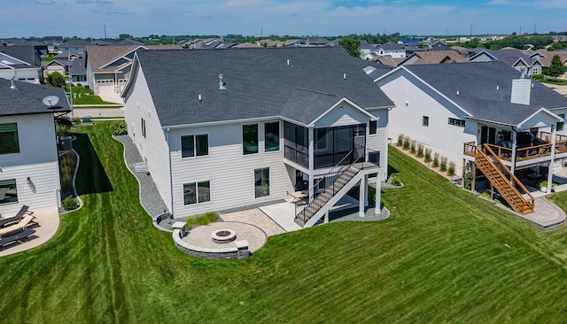 16320 Northpark Dr, Urbandale, IA 50323 - rear view of property featuring an outdoor fire pit, stairway, a residential view, and a sunroom
