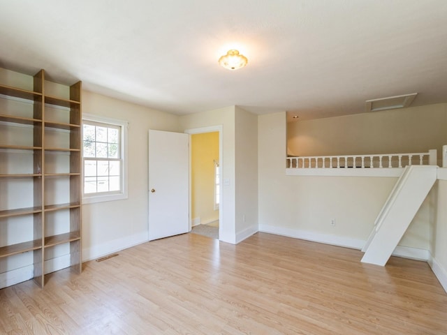 780 Iowa Ave, Martensdale, IA 50160 - empty room with wood finished floors and attic access