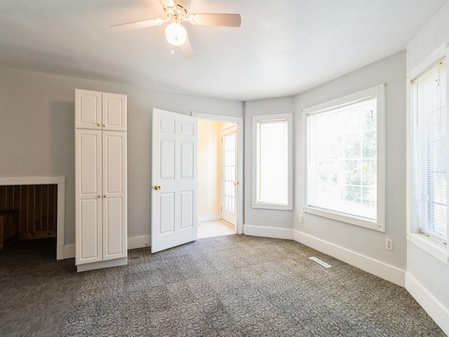 780 Iowa Ave, Martensdale, IA 50160 - unfurnished bedroom featuring carpet and ceiling fan