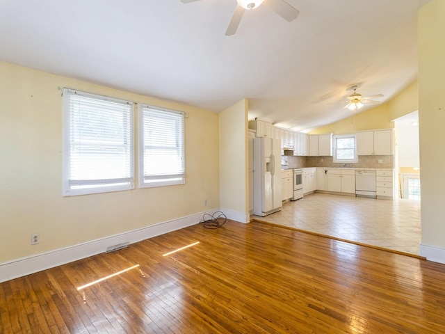 780 Iowa Ave, Martensdale, IA 50160 - unfurnished living room with ceiling fan, lofted ceiling, and light wood-style flooring