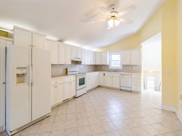 780 Iowa Ave, Martensdale, IA 50160 - kitchen featuring white appliances, tasteful backsplash, vaulted ceiling, light tile patterned flooring, and a ceiling fan