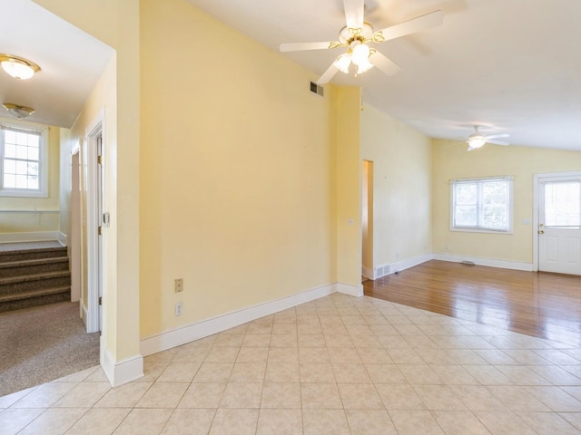 780 Iowa Ave, Martensdale, IA 50160 - empty room with vaulted ceiling, stairs, and a ceiling fan