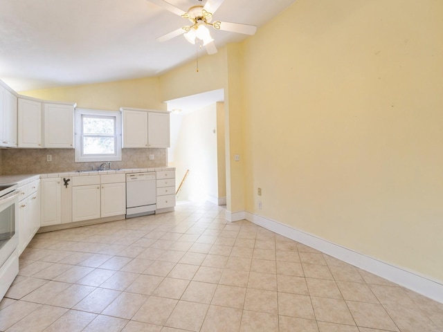780 Iowa Ave, Martensdale, IA 50160 - kitchen featuring lofted ceiling, white appliances, backsplash, a ceiling fan, and light tile patterned floors