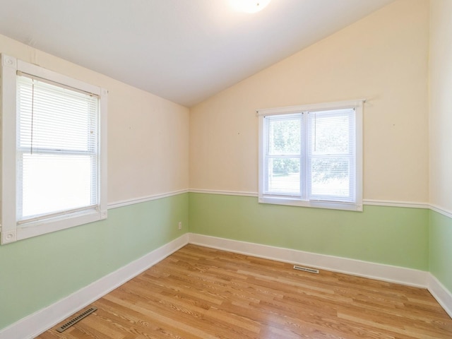 780 Iowa Ave, Martensdale, IA 50160 - spare room featuring vaulted ceiling and light wood-style floors