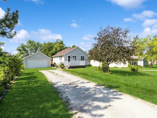 780 Iowa Ave, Martensdale, IA 50160 - view of front facade featuring an outdoor structure, a detached garage, a front lawn, and a wooden deck