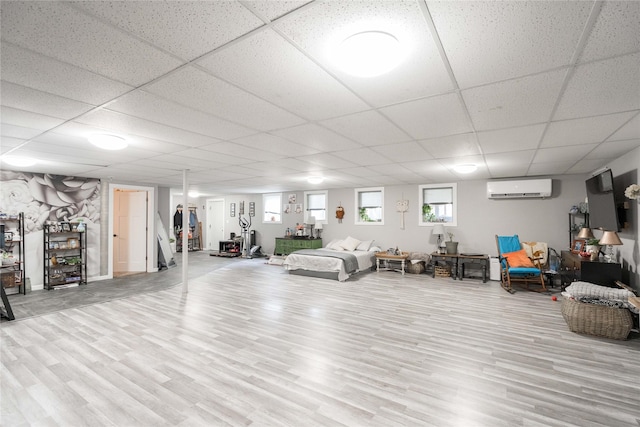 729 SE 3rd St, Ankeny, IA 50021 - interior space featuring a wall unit AC, a drop ceiling, and wood finished floors