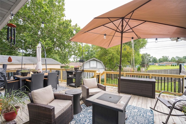 729 SE 3rd St, Ankeny, IA 50021 - wooden terrace featuring a storage unit, outdoor dining space, a fenced backyard, and an outdoor living space