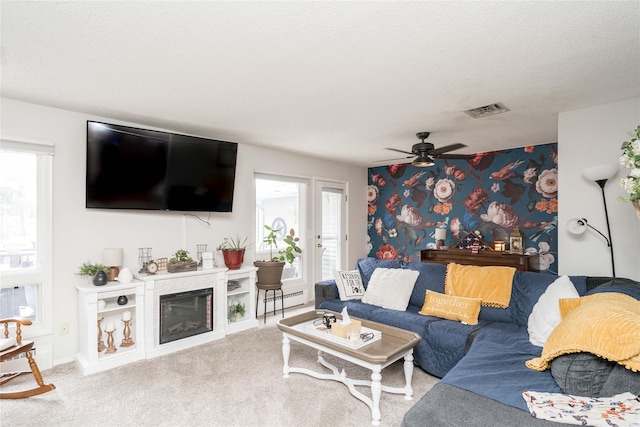 729 SE 3rd St, Ankeny, IA 50021 - living area featuring baseboard heating, carpet floors, a ceiling fan, and a textured ceiling