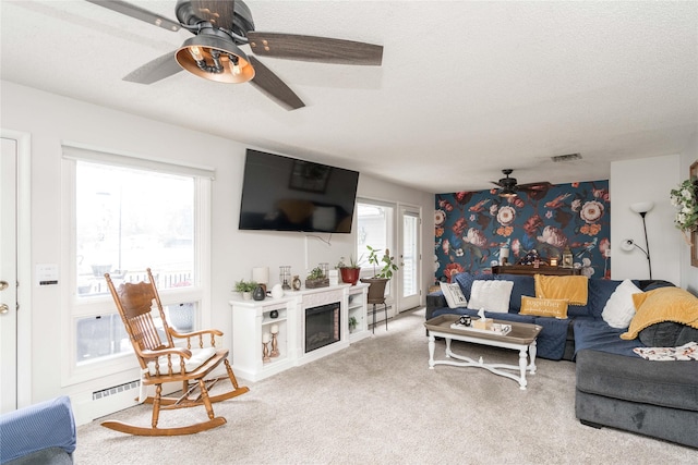 729 SE 3rd St, Ankeny, IA 50021 - carpeted living room featuring ceiling fan and a glass covered fireplace