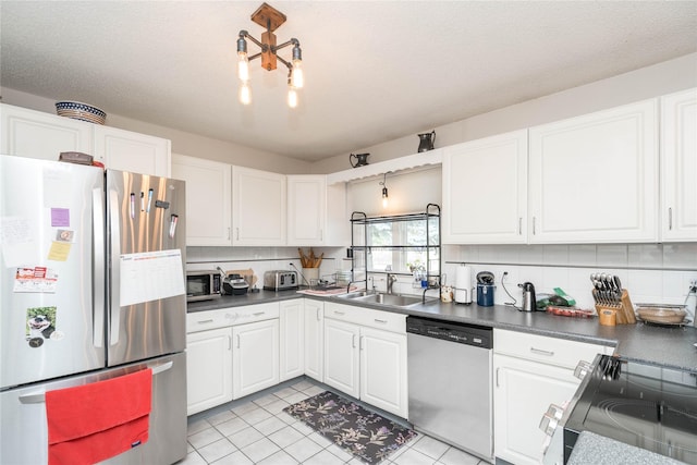 729 SE 3rd St, Ankeny, IA 50021 - kitchen featuring appliances with stainless steel finishes, white cabinets, and dark countertops