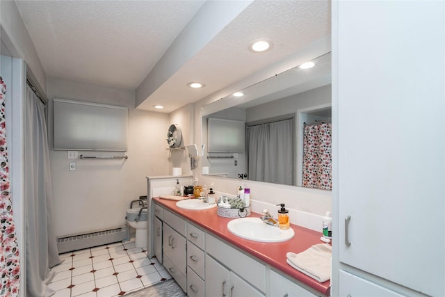 729 SE 3rd St, Ankeny, IA 50021 - full bathroom featuring baseboard heating, double vanity, tile patterned floors, recessed lighting, and a textured ceiling