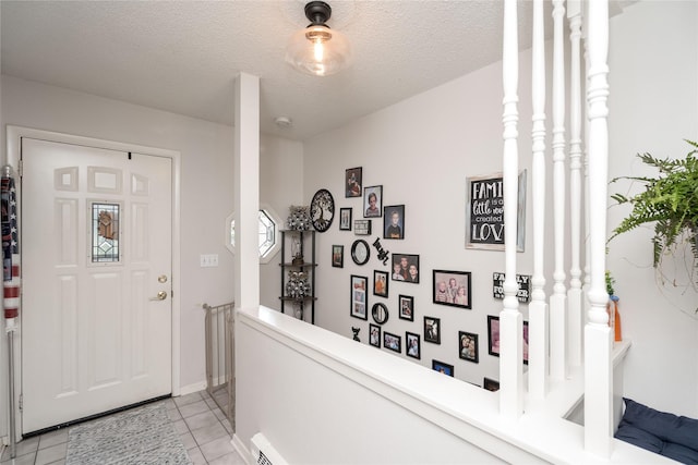 729 SE 3rd St, Ankeny, IA 50021 - foyer entrance featuring light tile patterned floors and a textured ceiling